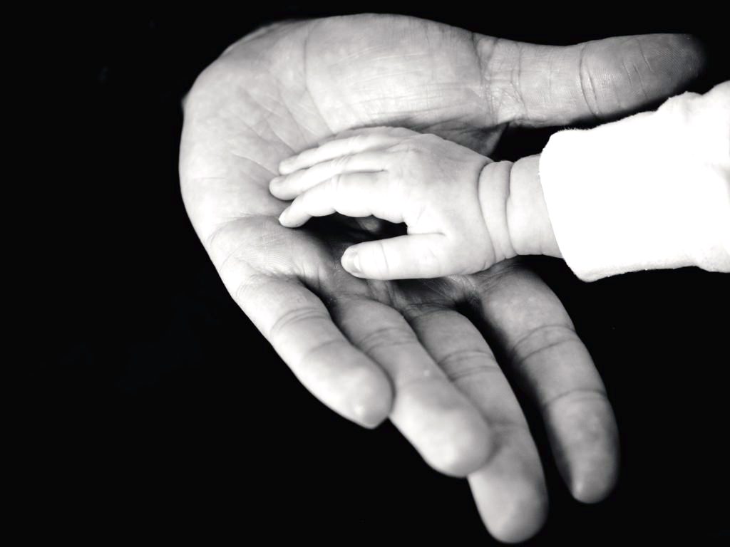 Father's hand holding a child's hand