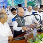 Rev. Dr. M.S. Samuel prays for the wine